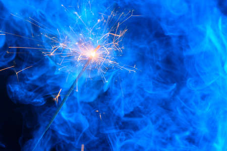 Bright burning sparkler bengal fire with smokeの写真素材