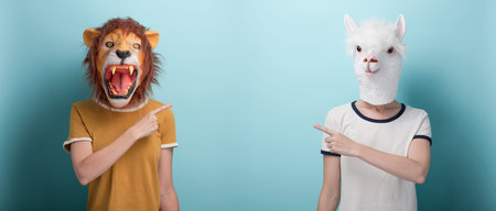 Woman in lion and alpaca mask pointing with index finger to the blank space, or pointing fingers...