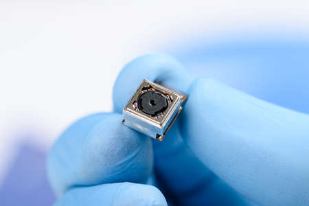 Smartphone single camera module in scientist handsの写真素材