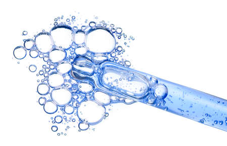 Cosmetic liquid dropper with clear blue serum in pipette with bubbles isolated on white background top viewの写真素材