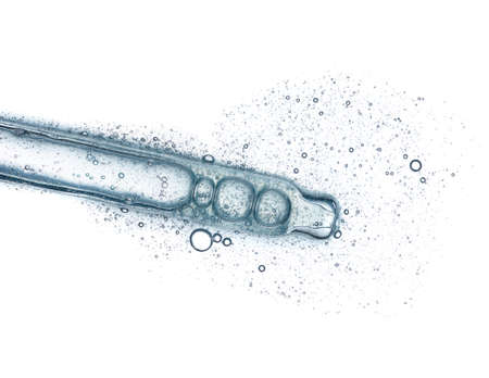 Cosmetic liquid dropper with clear serum in pipette with bubbles isolated on white background top viewの写真素材