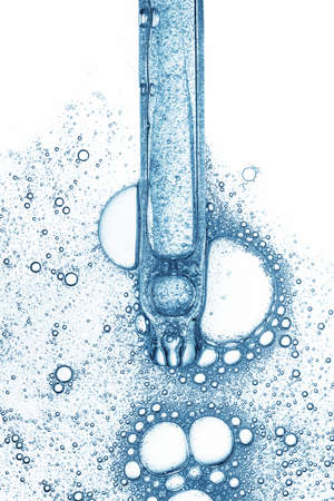 Blue serum liquid in cosmetic dropper pipette with bubbles isolated on white background top viewの写真素材
