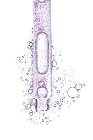 Pink serum in dropper isolated on white backgroundの写真素材