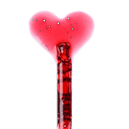 Cosmetic liquid dropper with red serum in pipette and in heart love shape with bubbles isolated on white background top viewの写真素材