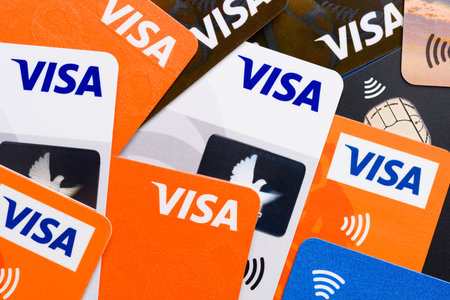 Krakow, Poland - April 27 2022: Close-up of Visa plastic credit payment cards with contactless pay symbol top viewのeditorial素材