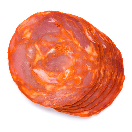 Spanish chorizo salami sausage slices, with pork meat and paprika, isolated on white background top view flat layの写真素材