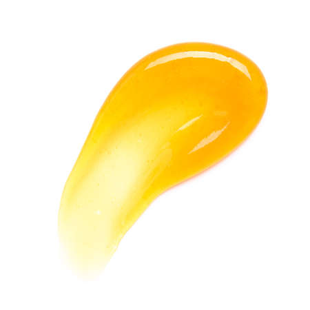 Transparent yellow gel cream smear smudge with bubbles macro isolated on white background top viewの写真素材