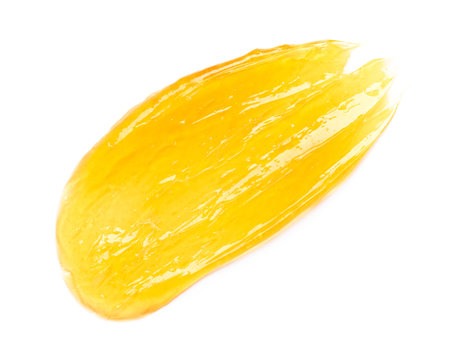 Yellow gel sugar honey smear smudge macro isolated on white background top viewの写真素材