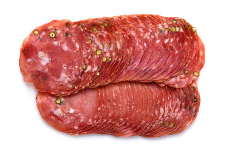 Dried smoked salami sausage slices stack with pepper isolated on white background top viewの写真素材
