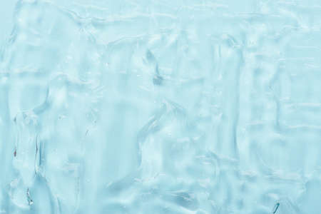 Clear cosmetic skincare aloe gel with bubbles on blue background texture top viewの写真素材