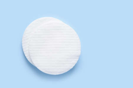 White new clean cotton pads on blue background top view flay layの写真素材