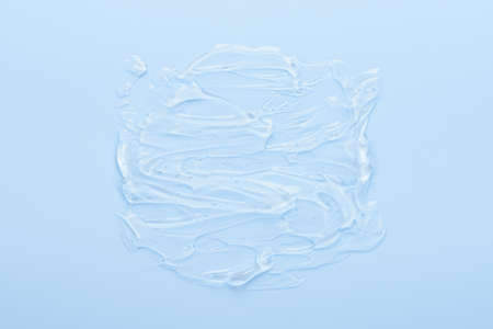 Cosmetic skin care aloe gel serum smear with bubbles isolated on blue background top viewの写真素材
