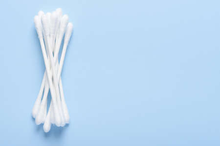 White new clean cotton swabs buds on blue background top view flay lay with side copy-spaceの写真素材