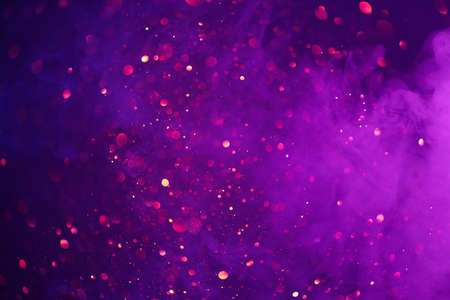 Colorful smoke clouds and shiny glitter lights bokeh abstract fantasy backgroundの写真素材