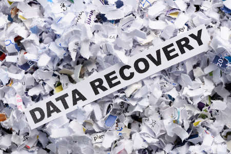 Words Data recovery on top of heap of cross shredded paper concept top viewの写真素材