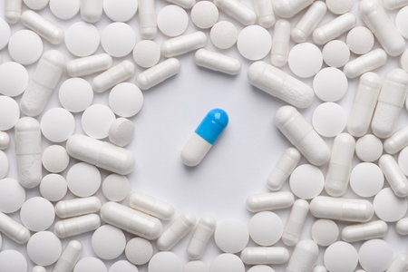 Single drug capsule stand out against group of white pills, superior new or different medicine or...