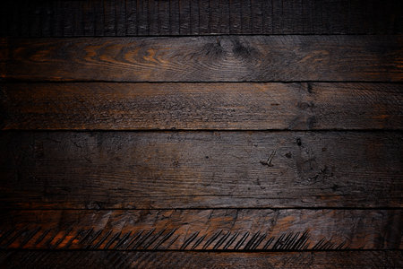 Dark stained rustic vignette wooden texture backgroundの写真素材