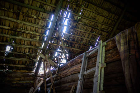 A leaky roof and sunlight passing through it in an old abandoned barn in the villageの写真素材