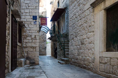 Old streets of a European city, stone walls and paving stonesの写真素材