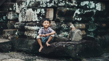 Siem Reap, Cambodia - July 14, 2013: Little boy in Angkor Watのeditorial素材