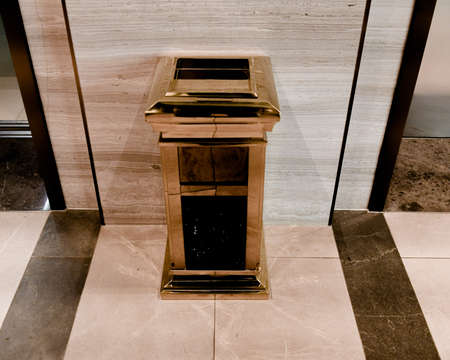 Ho Chi Minh City, 19 March 2021: Gold color, stainless steel, vertical elevator trash can with ashtray used in hotel or officeのeditorial素材