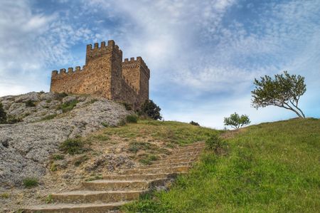 Way to the top. Stone staircase leading to the ancient tower on the hillの写真素材