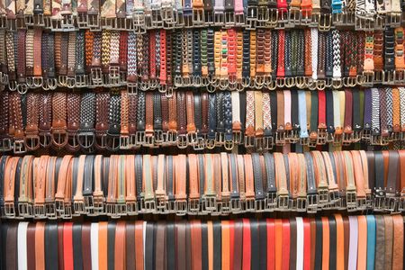 Belts hang down in a row for saleの写真素材