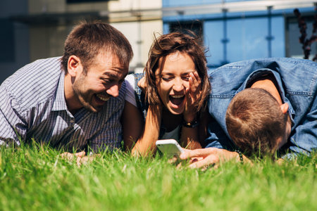 students lying on the grass near the University