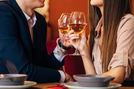 Happy young couple taking selfie with smart phone at cafeの写真素材