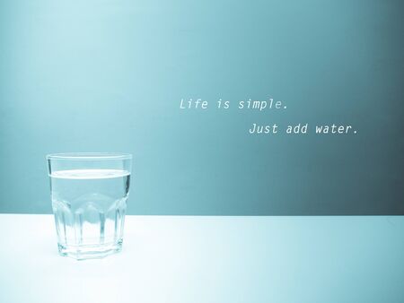 A glass of water with pastel blue backgroundの写真素材