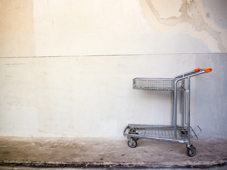 shopping cart with cement backgroundの写真素材