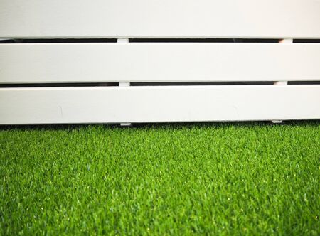 Green grass and white fenceの写真素材