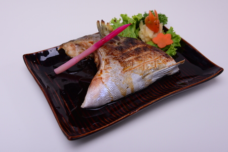 Buri-Kama Shioyaki ,Broiled Yellowtail Collar Shio-Yaki , Traditional Japanese food isolated on white backgroundの写真素材