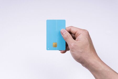 A hand holding a credit cardの写真素材