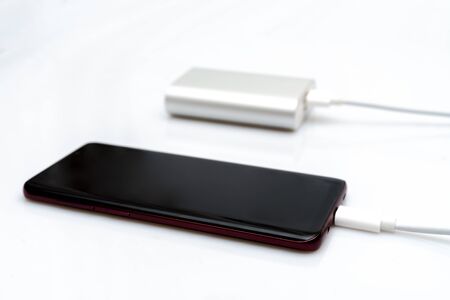 Mobile phone charging with power bankの写真素材