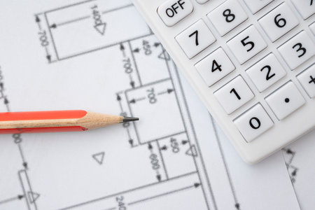 Architectural drawing, calculator and pencil