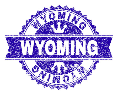WYOMING rosette stamp imitation with grunge style. Designed with round rosette, ribbon and small crowns. Blue vector rubber watermark of WYOMING title with corroded style.のイラスト素材