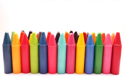 Colored chalks over white background
