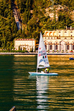 Riva del Garda, Trentino Alto Adige / Italy - September 24 2017: Small yacht sail on the lake against the backdrop of the mountains.のeditorial素材