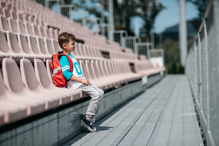 Portrait of a schoolboy with a bag taking a break from schoolの写真素材