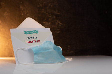 White Envelope with Positive Coronavirus Test Result. Still Photo of White Opened Envelope Showing...