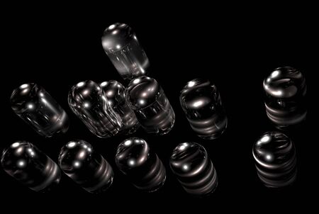 Small glass capsules on black backgroundの写真素材