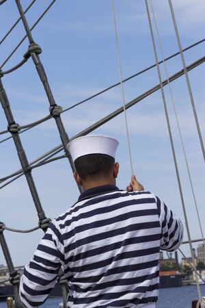 Sailor addictive rope on a sailing shipの写真素材