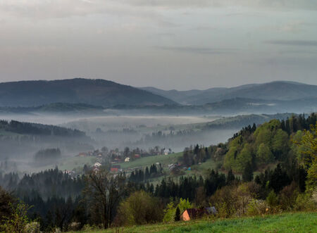 Fog in the Zywiec Beskids, Poland during the sunriseの写真素材