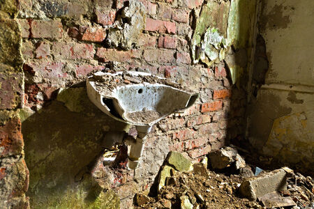 Destroyed old washbasin in the basement of the buildingの写真素材