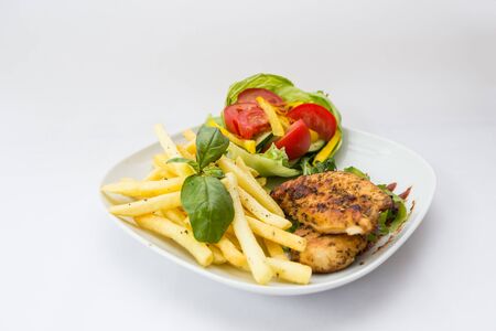 Fillet of chicken and chips served at dinnerの写真素材