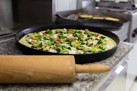 Preparation for baking pizza in the restaurant and in the background meat to hamburerówの写真素材
