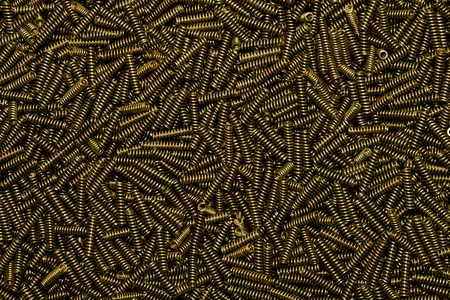Luxury industrial background of many small golden galvanized coiled springsの写真素材