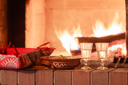 Two glasses of vodka at a firewood oven backgroundの写真素材
