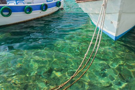 Boats in clear turquoise sea water on Greek island Kalymnosの写真素材